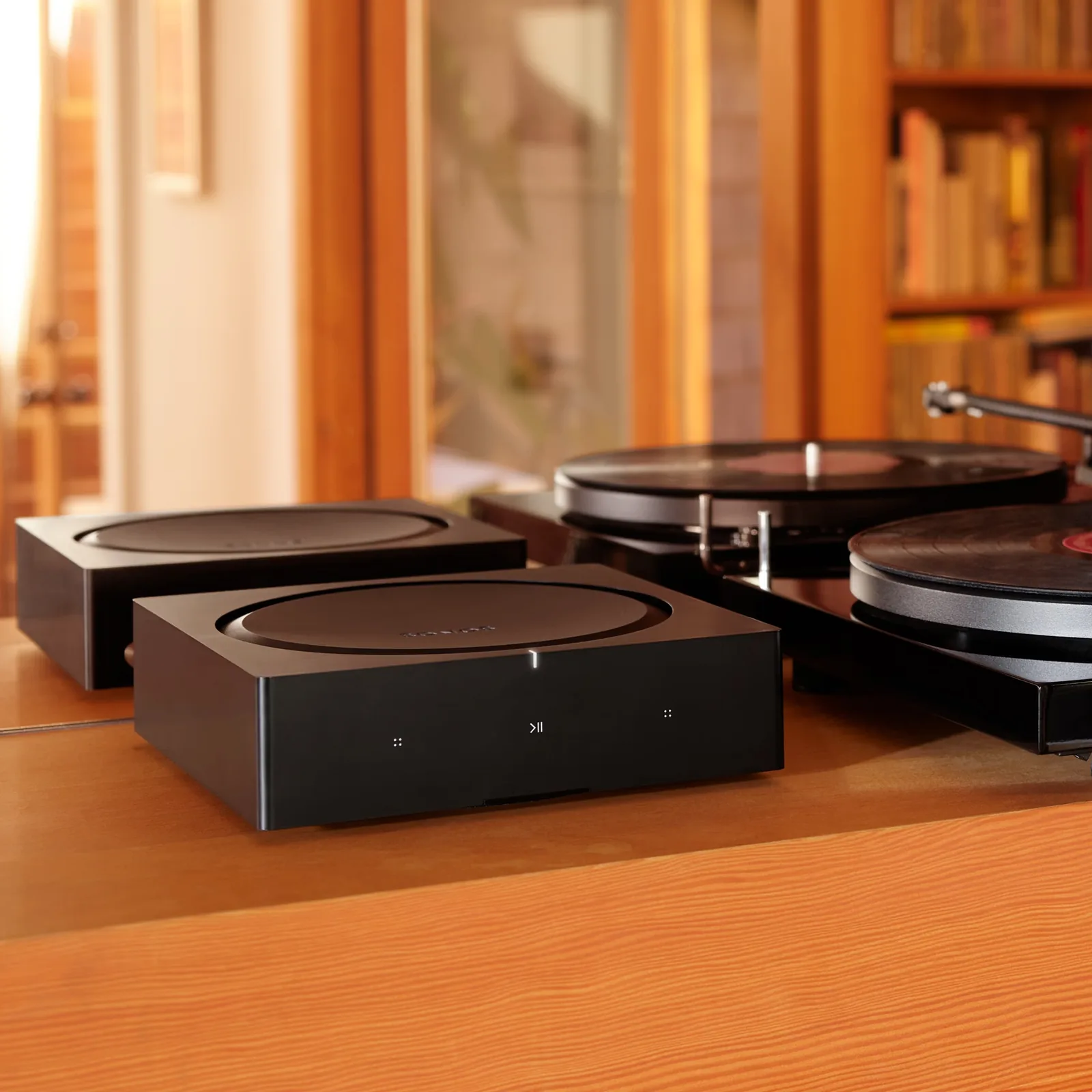 מגבר סטרימינג Sonos Amp, ליד פטיפון על שידה